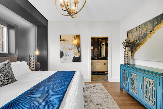 bedroom with a chandelier, dark wood-type flooring, ensuite bathroom, and baseboards