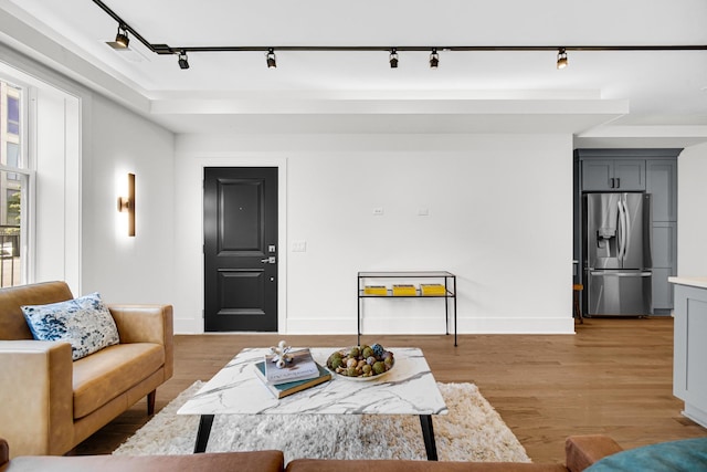 living area featuring wood finished floors and baseboards