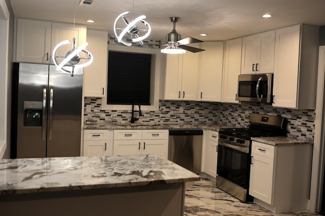 kitchen featuring white cabinetry, ceiling fan, and stainless steel appliances