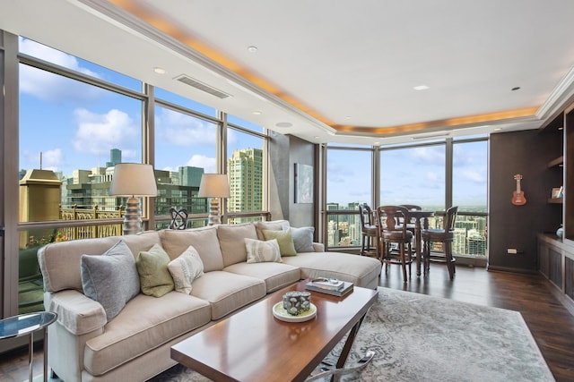 living room featuring dark hardwood / wood-style floors, plenty of natural light, and a wall of windows