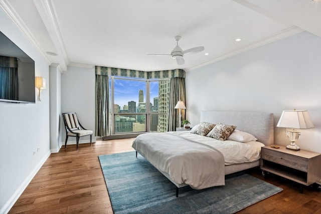 bedroom with hardwood / wood-style flooring, ceiling fan, and crown molding