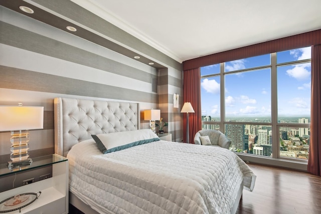 bedroom featuring wood-type flooring and ornamental molding