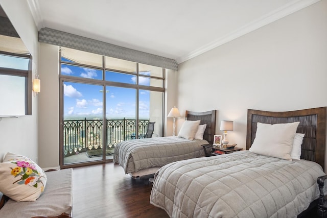 bedroom with access to exterior, dark hardwood / wood-style flooring, expansive windows, and ornamental molding