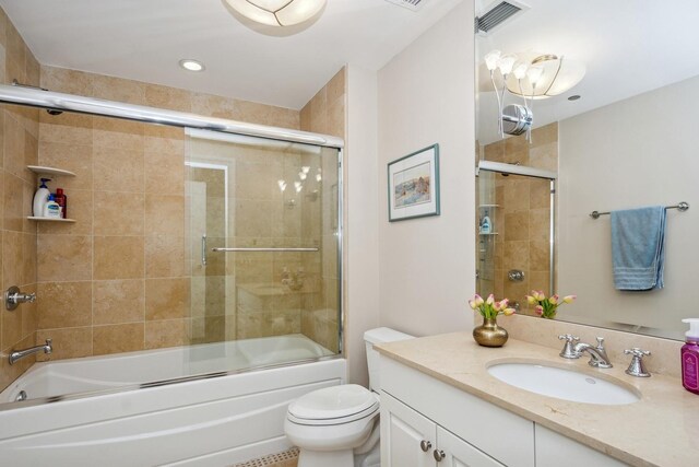 full bathroom with shower / bath combination with glass door, vanity, and toilet