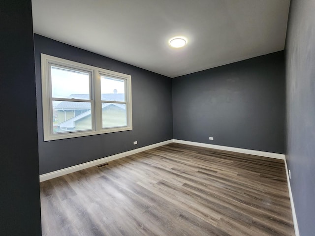 unfurnished room with hardwood / wood-style floors