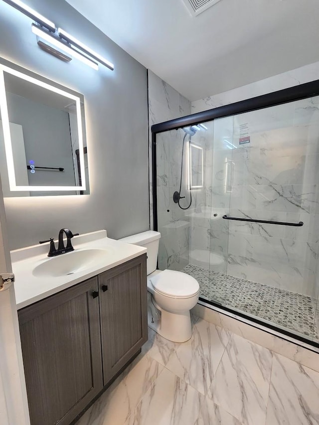 bathroom with vanity, toilet, and walk in shower