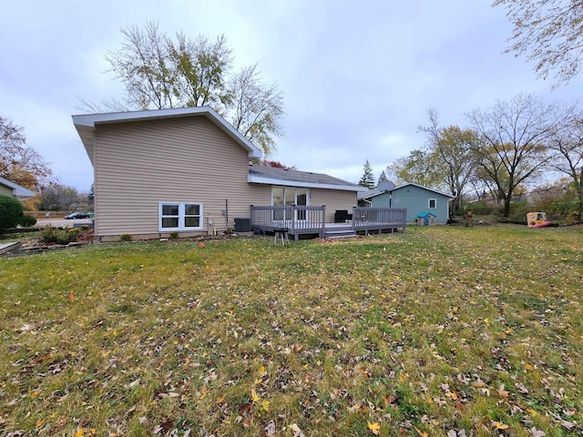 back of property featuring cooling unit, a yard, and a wooden deck