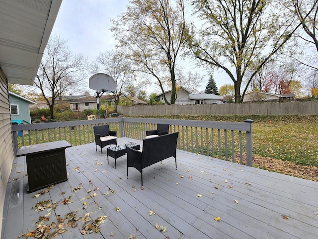 wooden deck featuring outdoor lounge area and a yard