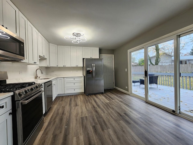 kitchen featuring dark hardwood / wood-style flooring, sink, white cabinetry, and stainless steel appliances