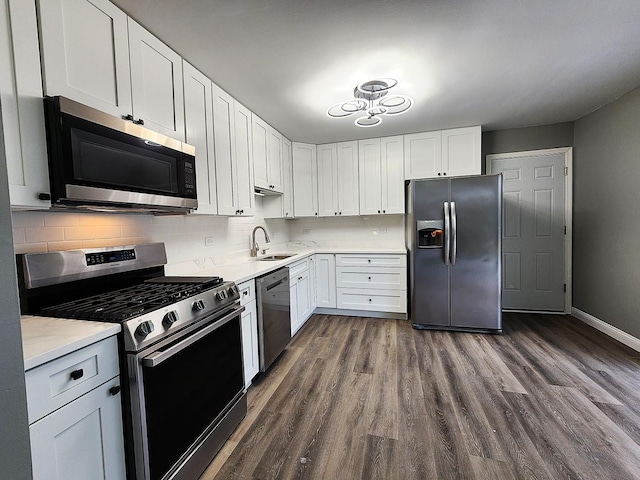 kitchen featuring dark hardwood / wood-style flooring, sink, white cabinets, and appliances with stainless steel finishes