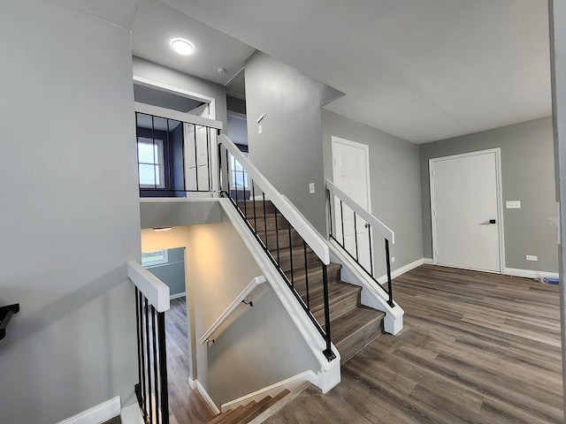 stairway with hardwood / wood-style flooring