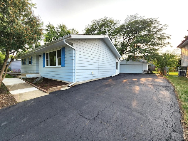 view of side of home with an outdoor structure and a garage