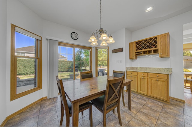 dining room featuring a healthy amount of sunlight and an inviting chandelier