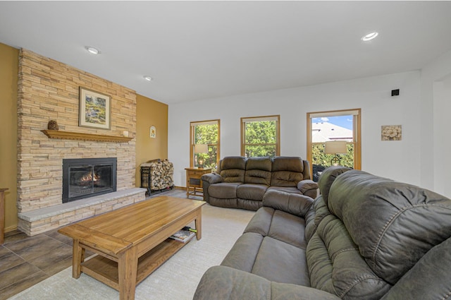 living room with a stone fireplace