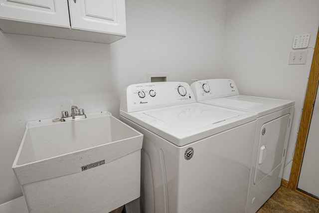 washroom featuring washer and clothes dryer, cabinets, and sink