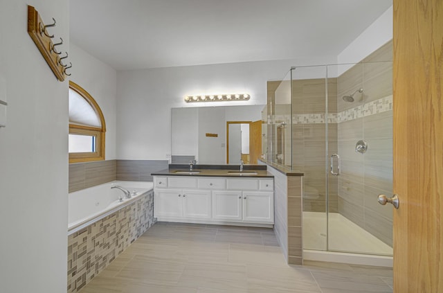 bathroom featuring tile patterned floors, vanity, and separate shower and tub