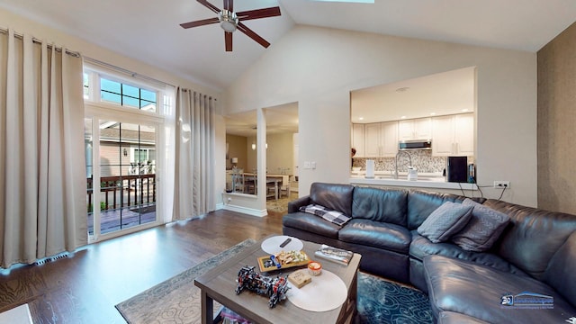 living room featuring ceiling fan, sink, high vaulted ceiling, and dark hardwood / wood-style floors