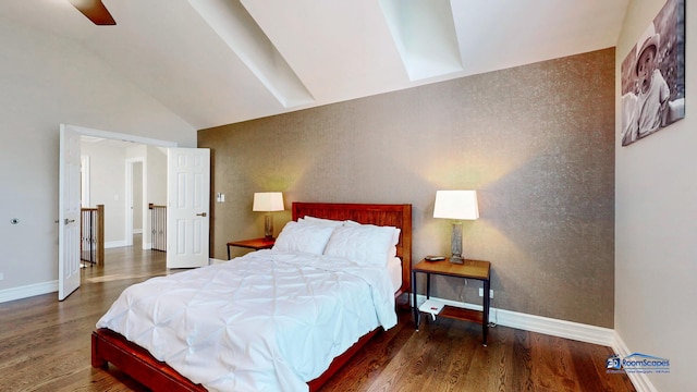 bedroom with ceiling fan, dark hardwood / wood-style flooring, and lofted ceiling