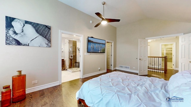 bedroom with ceiling fan, lofted ceiling, dark wood-type flooring, and ensuite bath