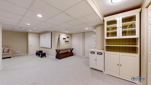 interior space with light carpet and a drop ceiling