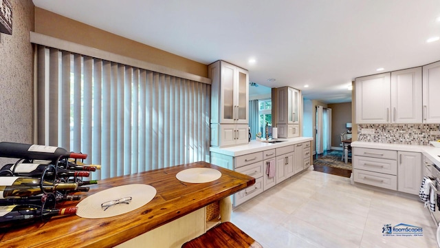 bathroom with decorative backsplash and sink