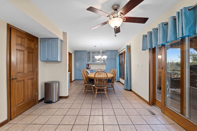 dining room with ceiling fan with notable chandelier and light tile patterned floors