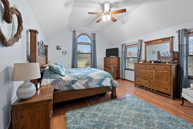 bedroom featuring lofted ceiling, ceiling fan, and light wood-type flooring