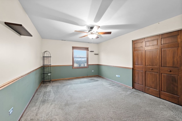 unfurnished bedroom featuring light carpet, a closet, and ceiling fan