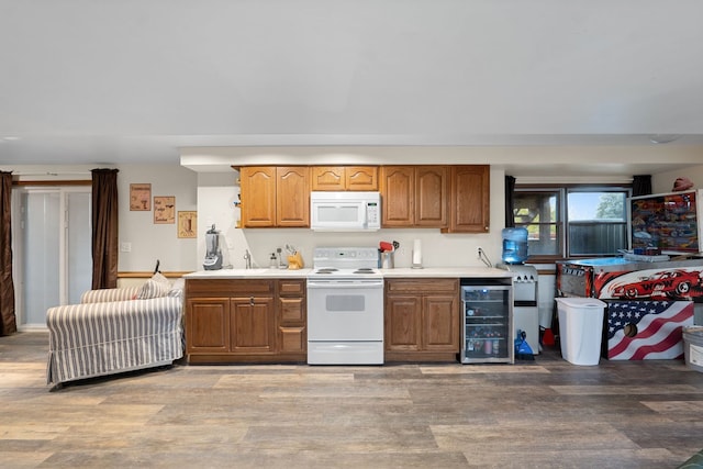 kitchen featuring beverage cooler, white appliances, and light hardwood / wood-style flooring