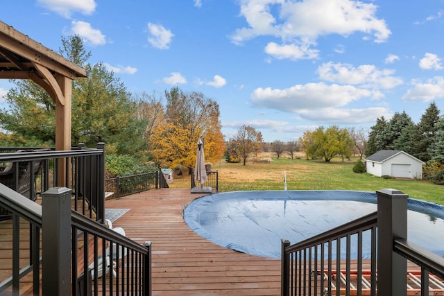 deck with a yard and a covered pool