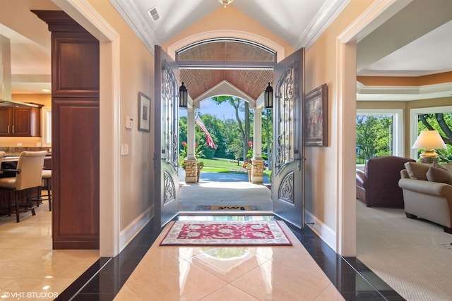 entrance foyer featuring plenty of natural light, lofted ceiling, and crown molding