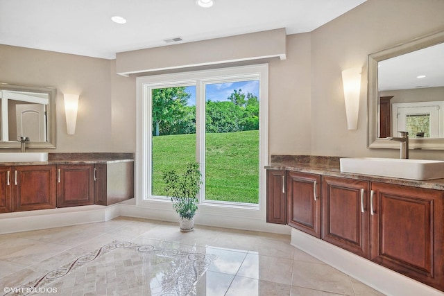 bathroom featuring tile patterned flooring, vanity, and plenty of natural light