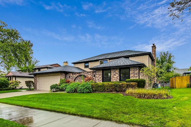 view of front facade with a garage and a front lawn