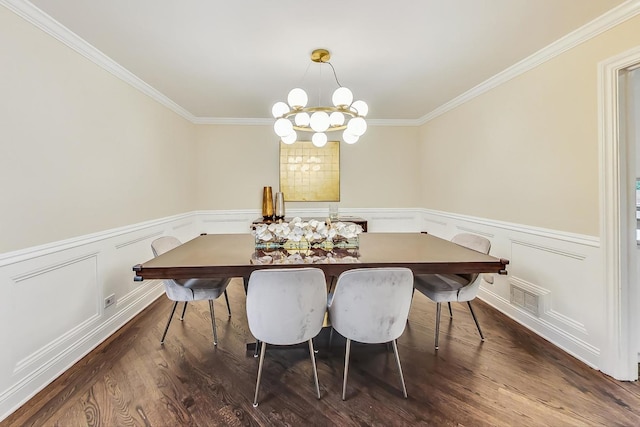 dining area with dark wood-type flooring, crown molding, and a notable chandelier