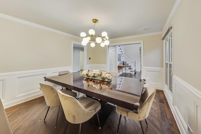 dining space with ornamental molding, dark wood-type flooring, and an inviting chandelier