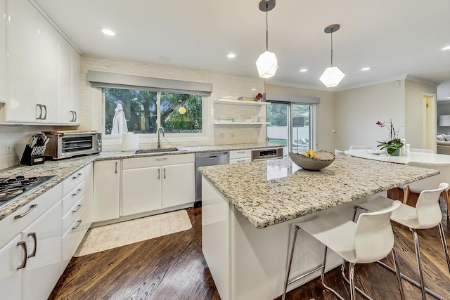 kitchen featuring backsplash, white cabinetry, sink, and appliances with stainless steel finishes