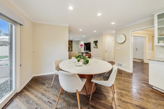 dining area with dark wood-type flooring and ornamental molding