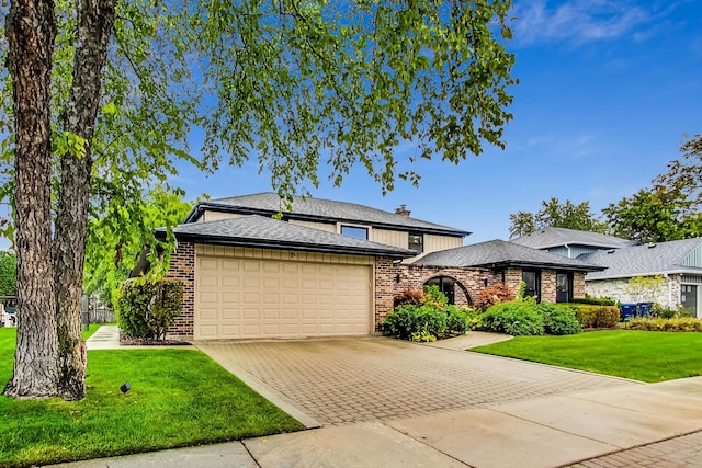 view of front facade with a front yard and a garage