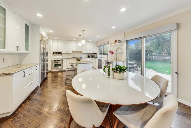 dining room with sink and dark hardwood / wood-style floors