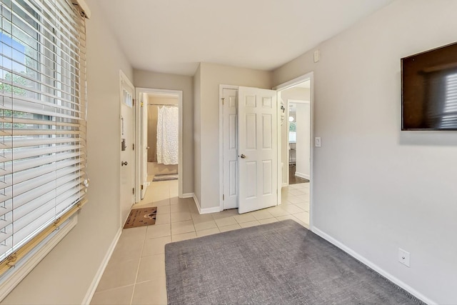 hall with light tile patterned flooring