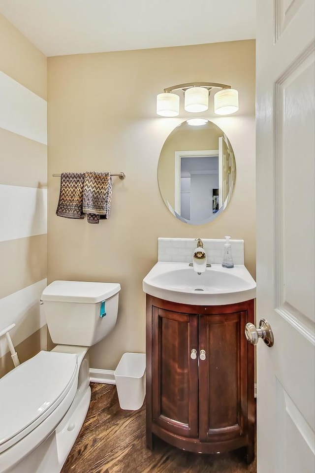 bathroom featuring hardwood / wood-style flooring, vanity, and toilet