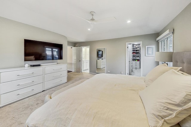 carpeted bedroom featuring ceiling fan, a closet, and a spacious closet