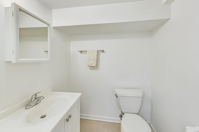 bathroom with tile patterned flooring, vanity, and toilet