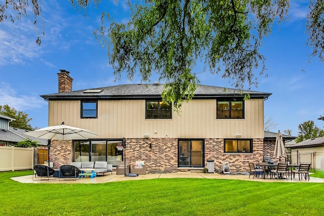 back of house featuring central AC, a yard, a patio, and an outdoor hangout area