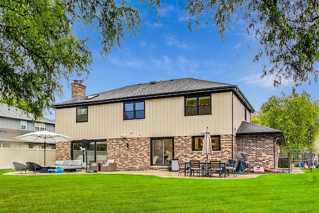 rear view of property with a lawn, a patio area, and an outdoor hangout area