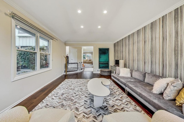 living room with hardwood / wood-style floors, a healthy amount of sunlight, and crown molding