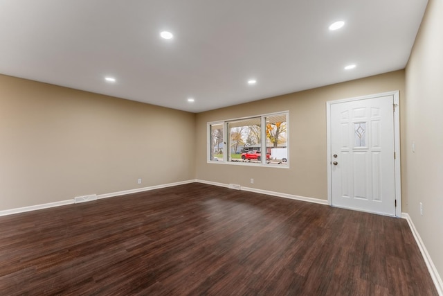 spare room featuring dark hardwood / wood-style flooring