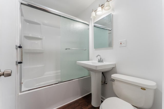 bathroom featuring shower / bath combination with glass door, wood-type flooring, and toilet