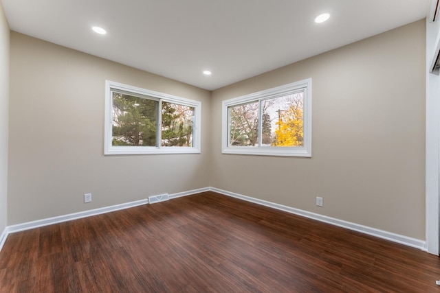 spare room with dark wood-type flooring