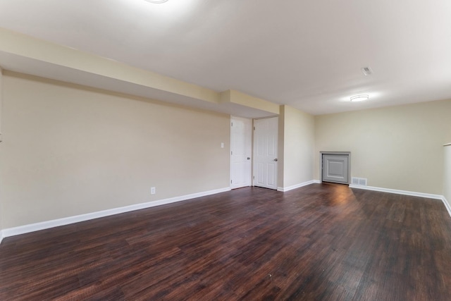 basement with dark hardwood / wood-style flooring